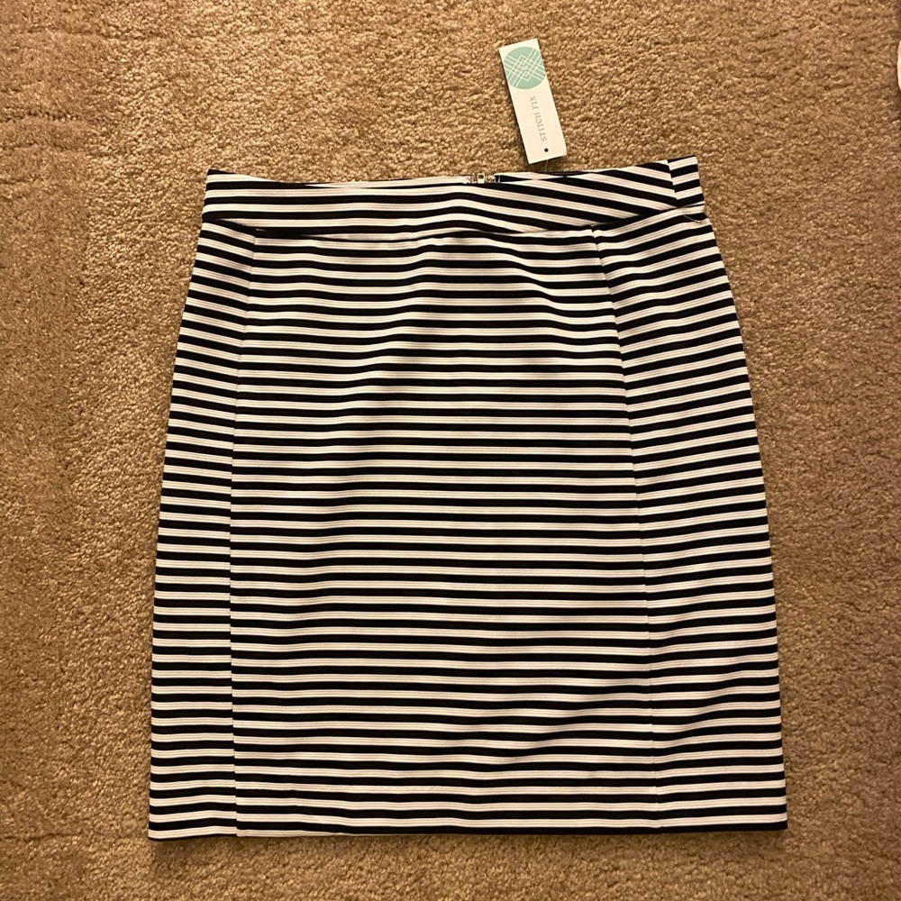 Knee-length black and white skirt.